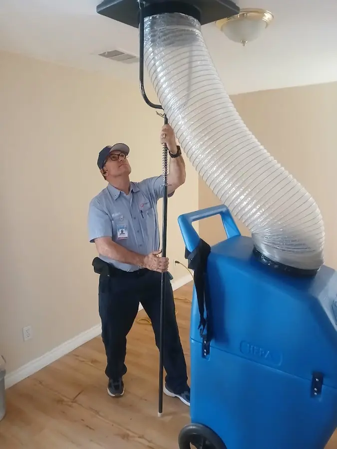Furnace Tune-Up technician using HEPA equipment in Santa Cruz